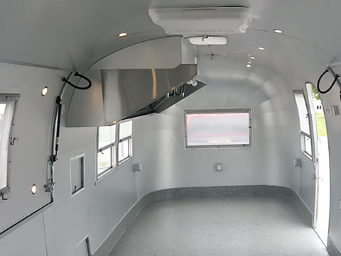 Airstream interior wrapped in aluminum with complete range hood