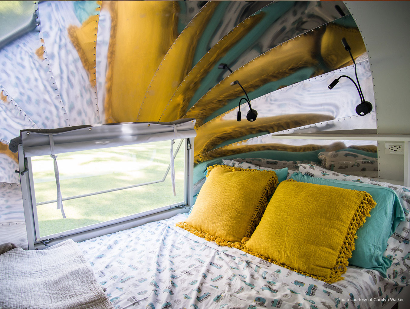 Airstream Overlander bedroom with shiny aluminum endcap